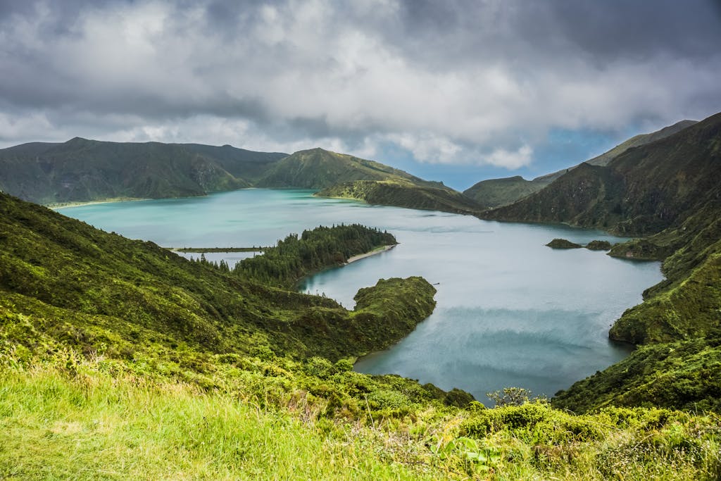 Breathtaking view of Lagoa do Fogo surrounded by lush greenery and mountains in the Azores.