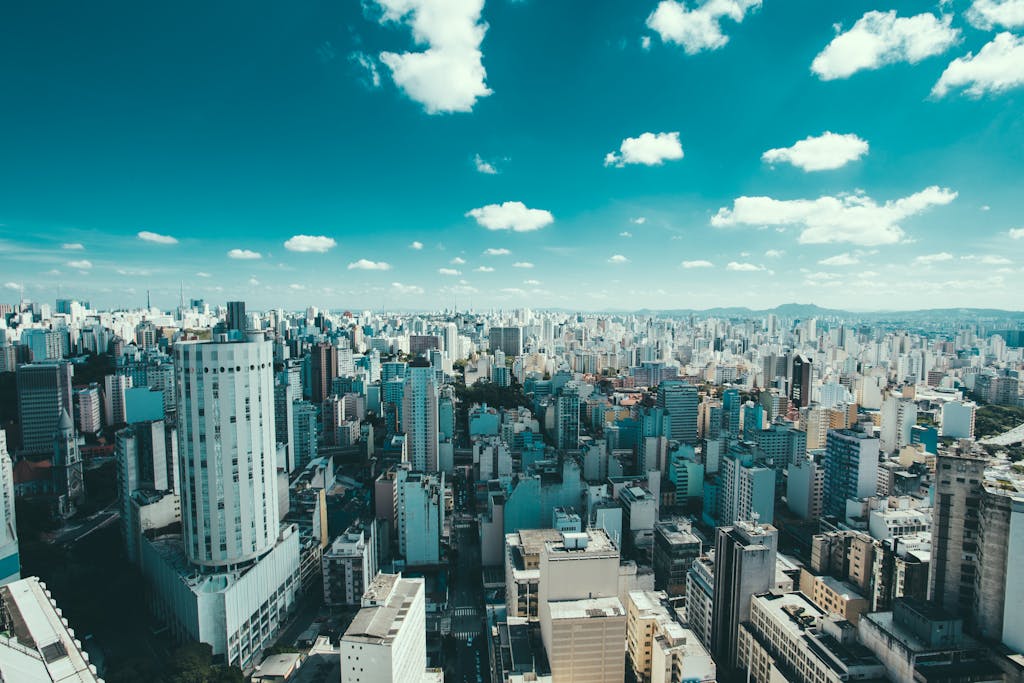 Expansive aerial view of Sao Paulo showcasing skyscrapers and a vibrant urban skyline under a blue sky.