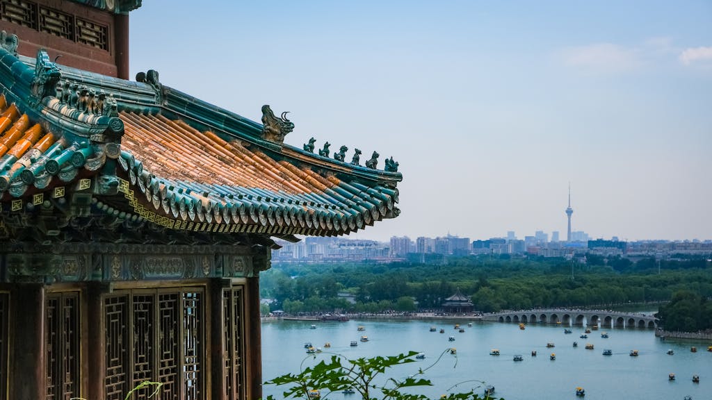 Elegant Chinese architecture with city skyline and lake view in Beijing, China.