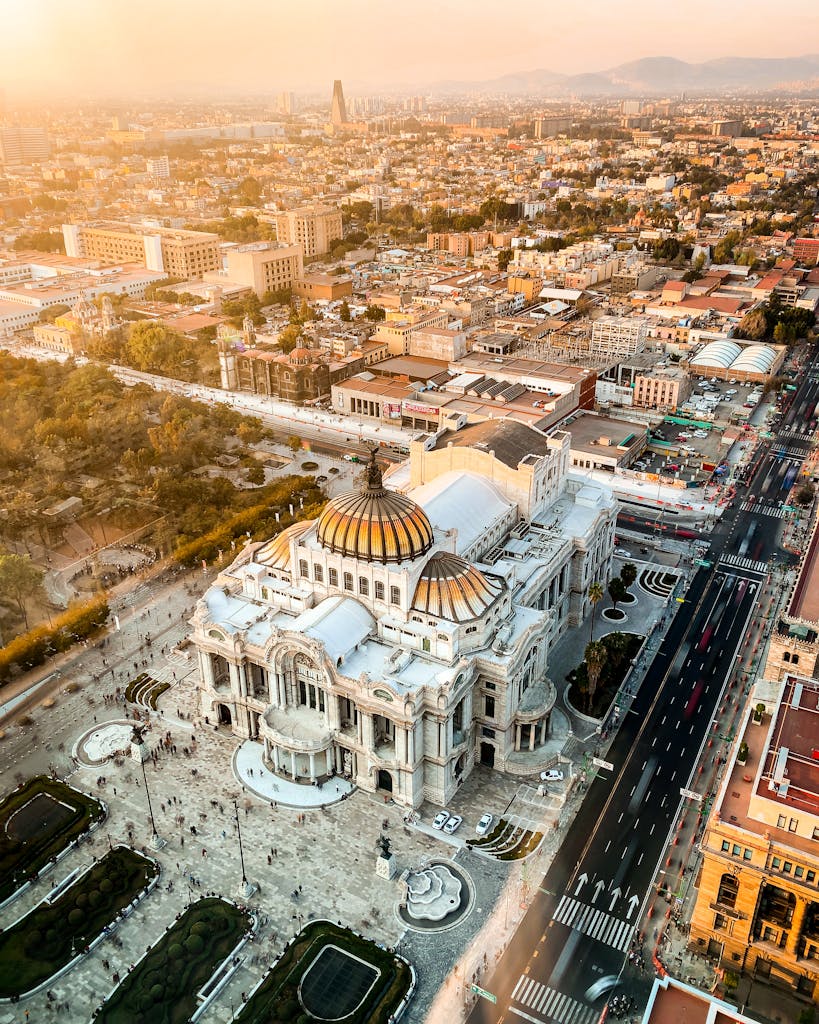 Stunning aerial photo of Palacio de Bellas Artes in Mexico City at sunset, showcasing urban architecture.