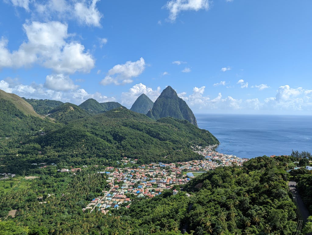 Stunning aerial view of Soufriere town and the iconic Pitons in Saint Lucia.