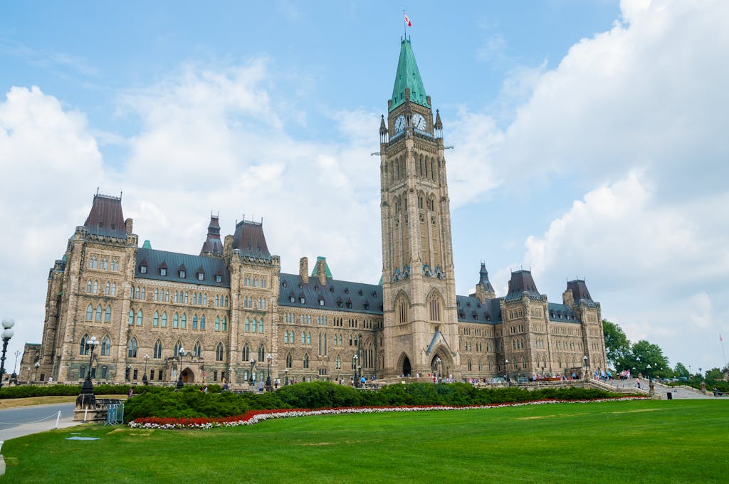 Stunning photo of Canada's Parliament Hill in Ottawa under a clear sky, showcasing Gothic Revival architecture.